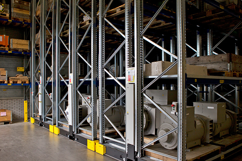 Metal shelving units with industrial equipment and wooden pallets are stored in a well-lit, clean warehouse. The complete and efficient organization supports seamless operations, making it ideal for businesses using quotation request generators.